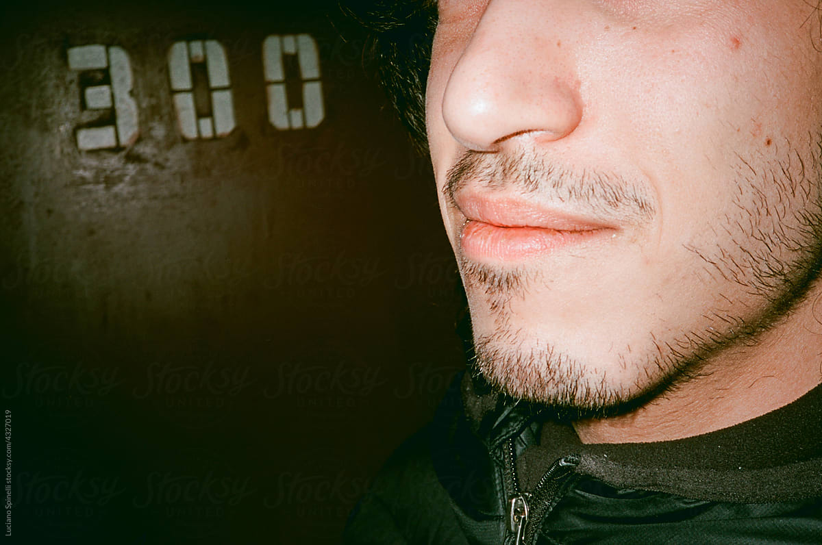 Close up of a young man face and the number 300 behind