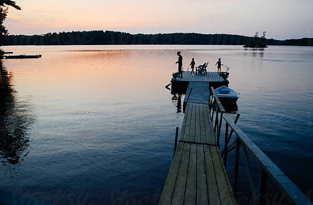 Silhouette Of A Little Girl Standing Near A Lake At Sunset by Stocksy  Contributor Cara Dolan - Stocksy
