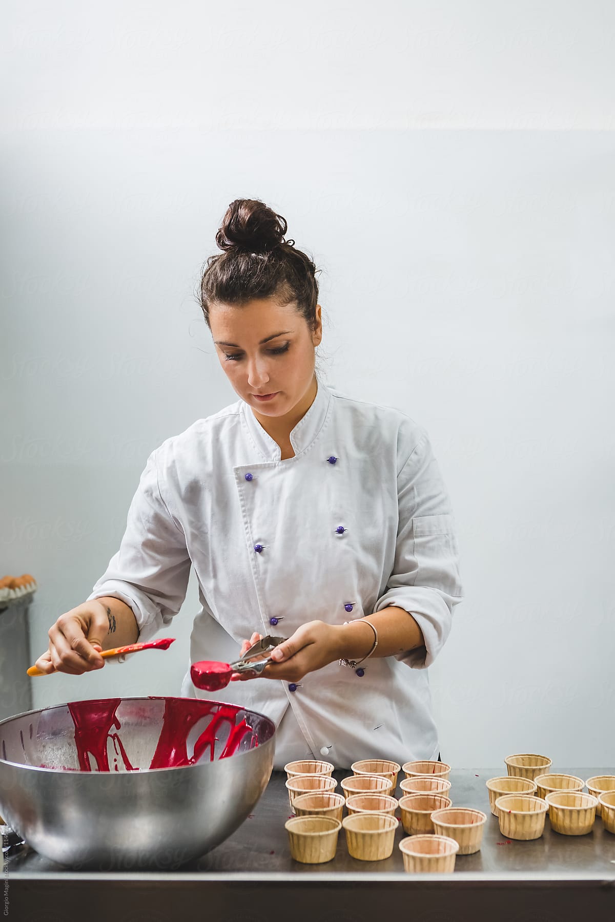 Woman Pastry Chef Preparing Red Batter Muffins to Bake