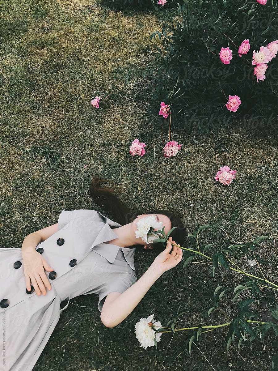 Woman Hiding Her Face Behind Flower By Stocksy Contributor Amor Burakova Stocksy