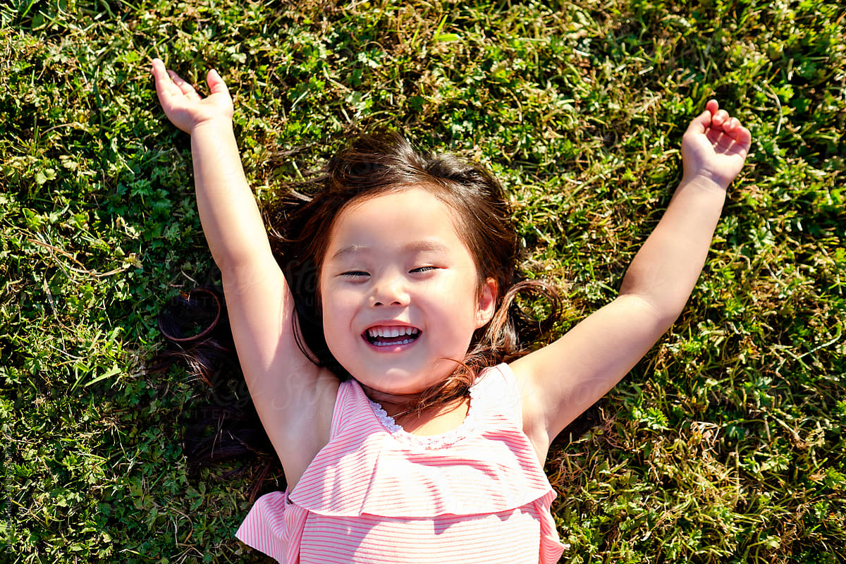Happy Asian Girl Outdoor In A Park Del Colaborador De Stocksy Take A