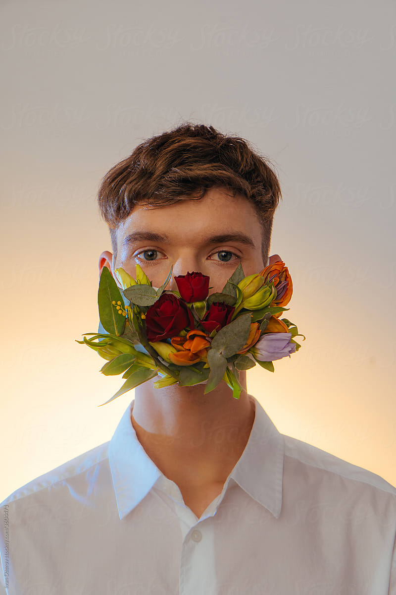 studio portrait of a man in a flower mask