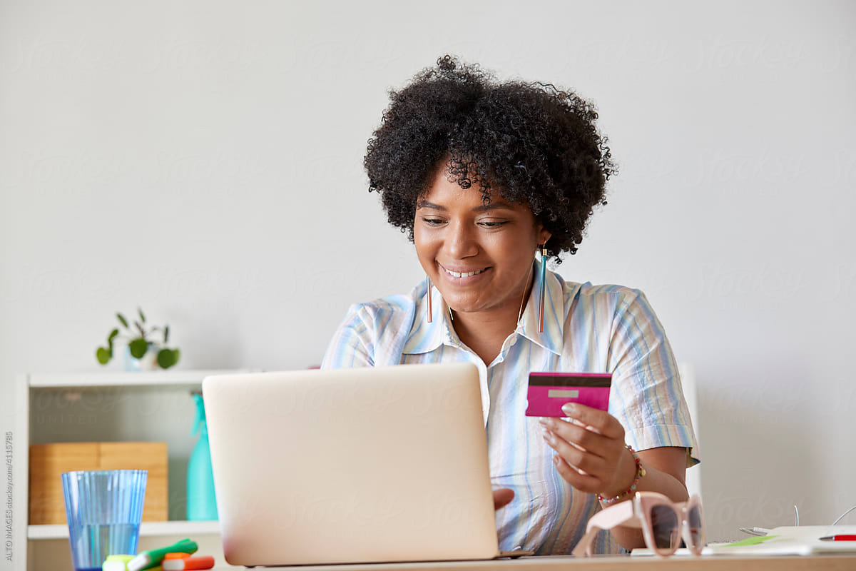 Smiling black office worker shopping online