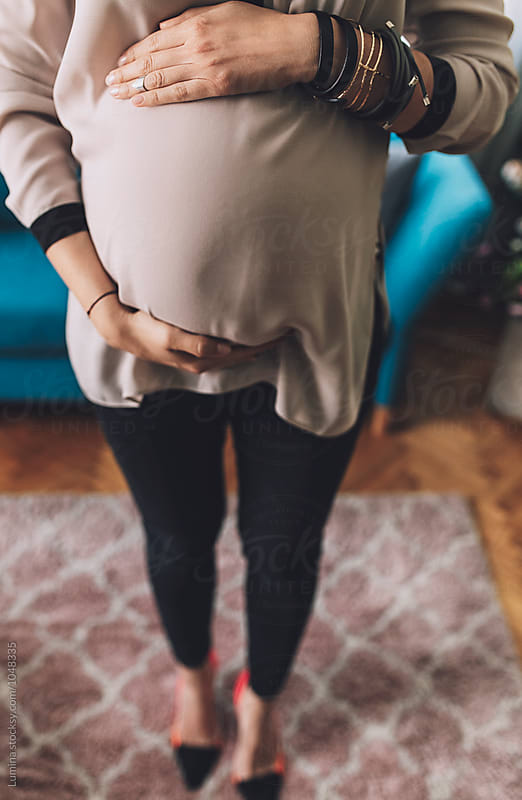 Pregnant Woman Holding Her Arms on Stomach