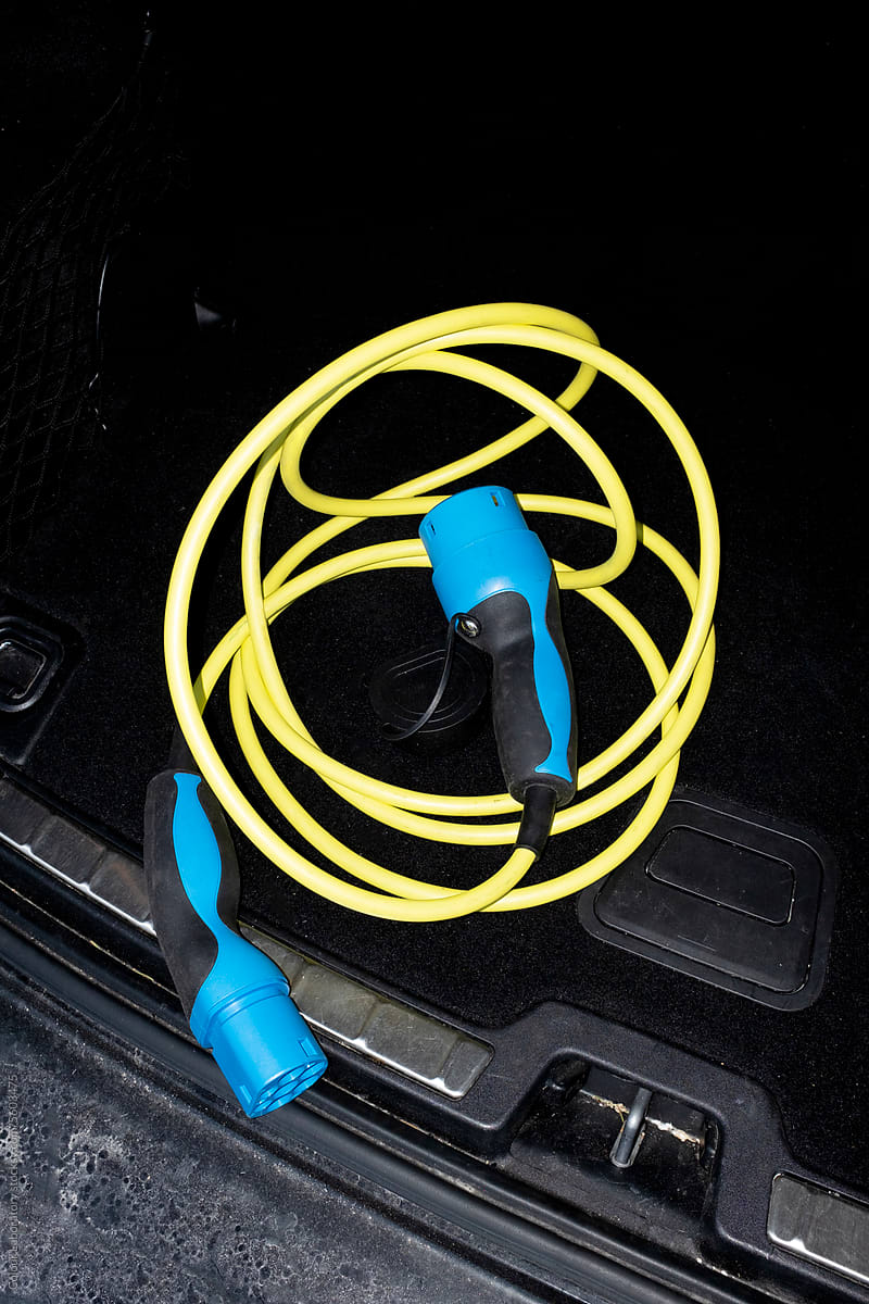 Photo of modern charger / wire of electric car with hard flashlight