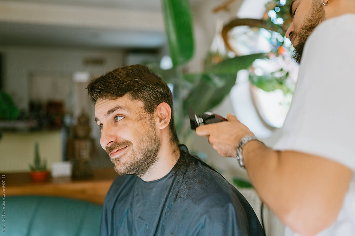 Man recieving a haircut at home