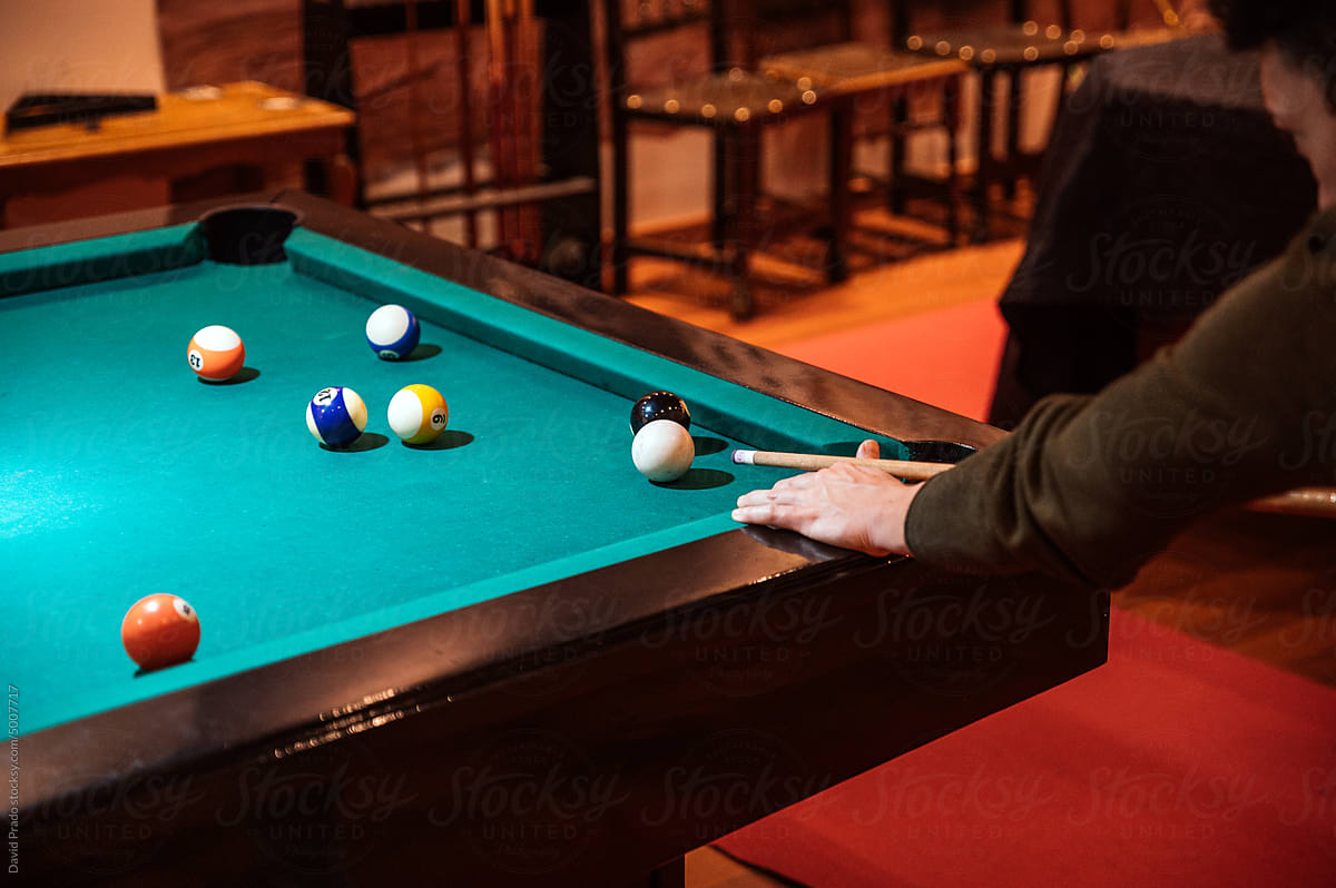 anonymous Focused sportsman playing pool in club
