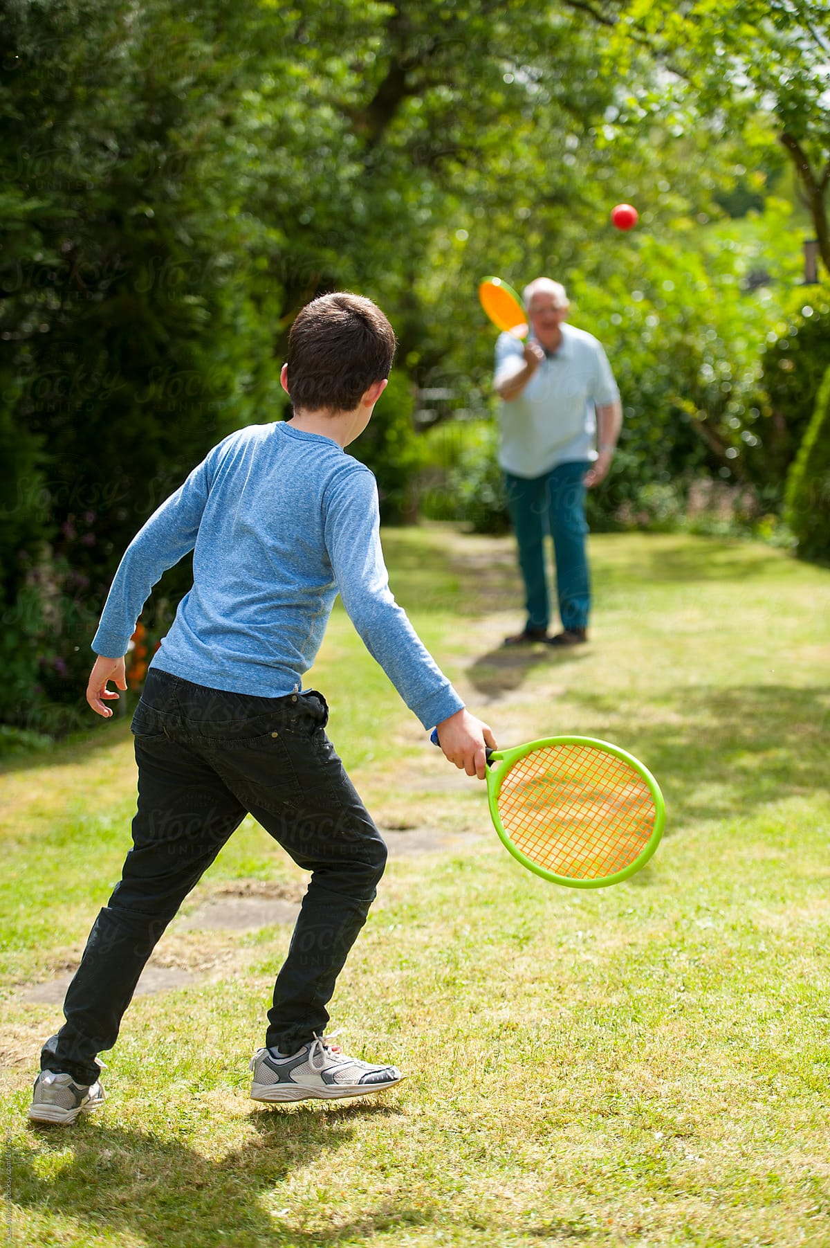 grandfather and grandson playing tennis