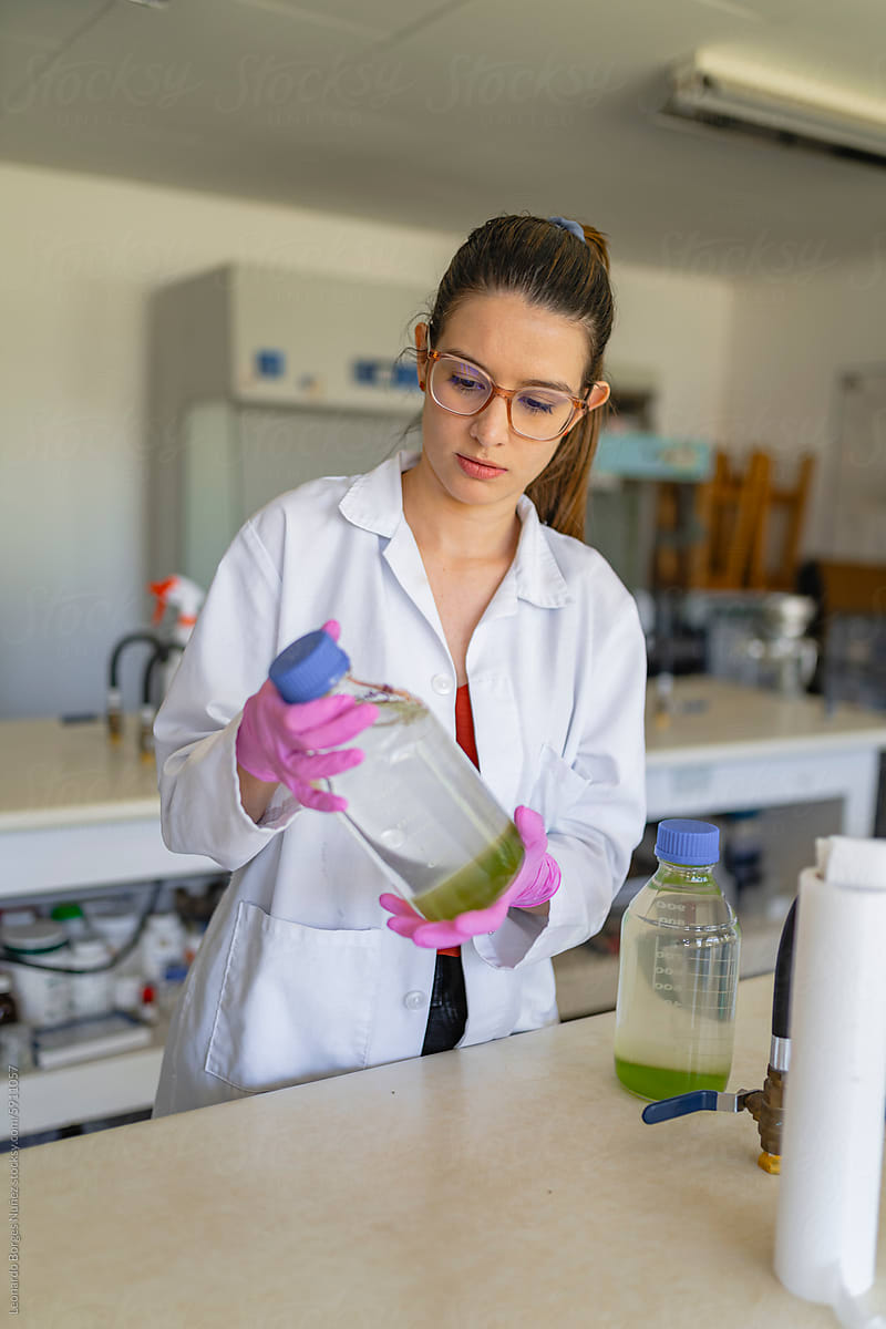 Young female scientist conducting chemical research in laboratory
