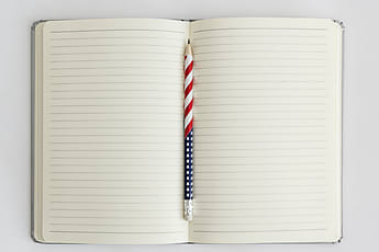 Stars And Stripes Pencil Among White Office Supplies by Stocksy  Contributor Melanie Kintz - Stocksy