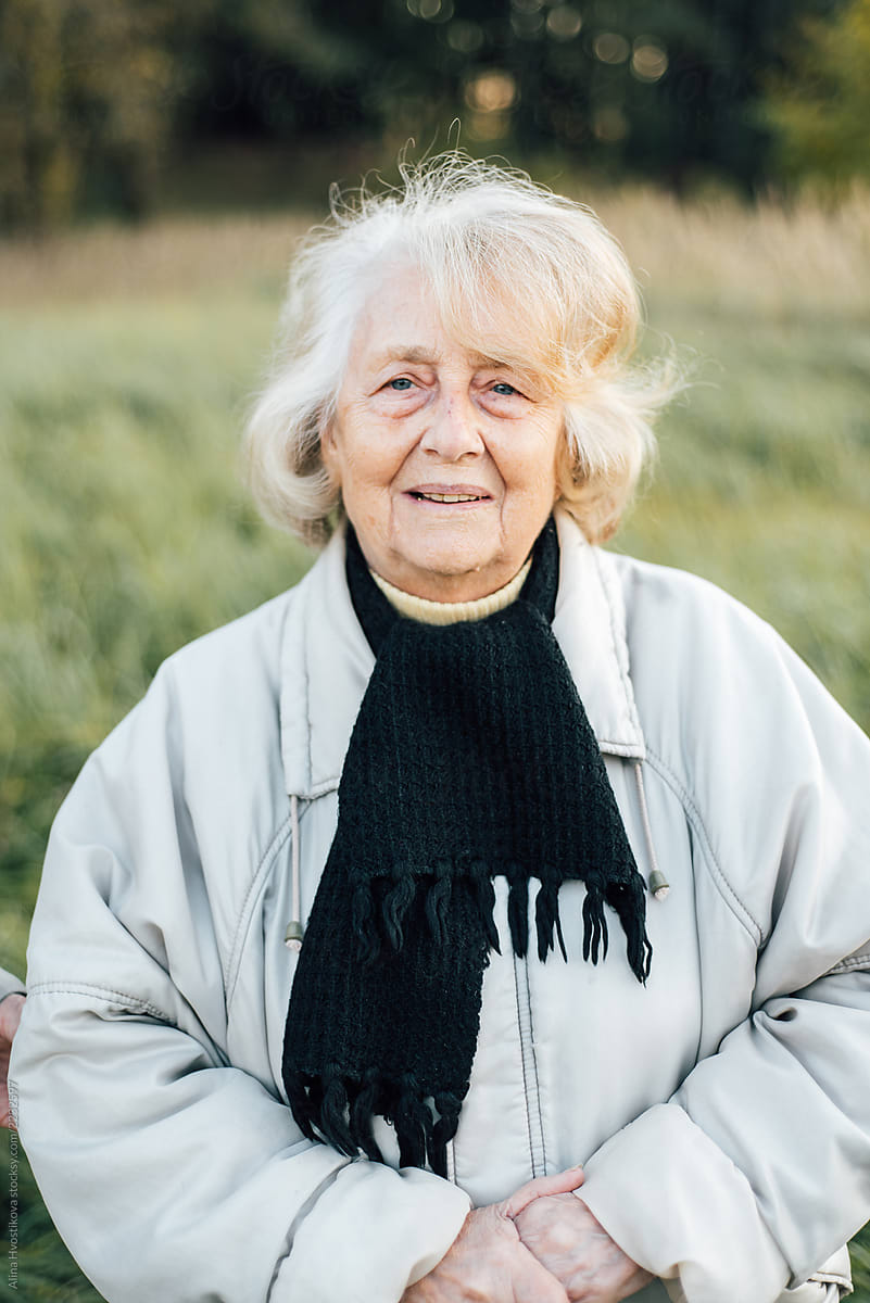 Elderly woman standing in nature