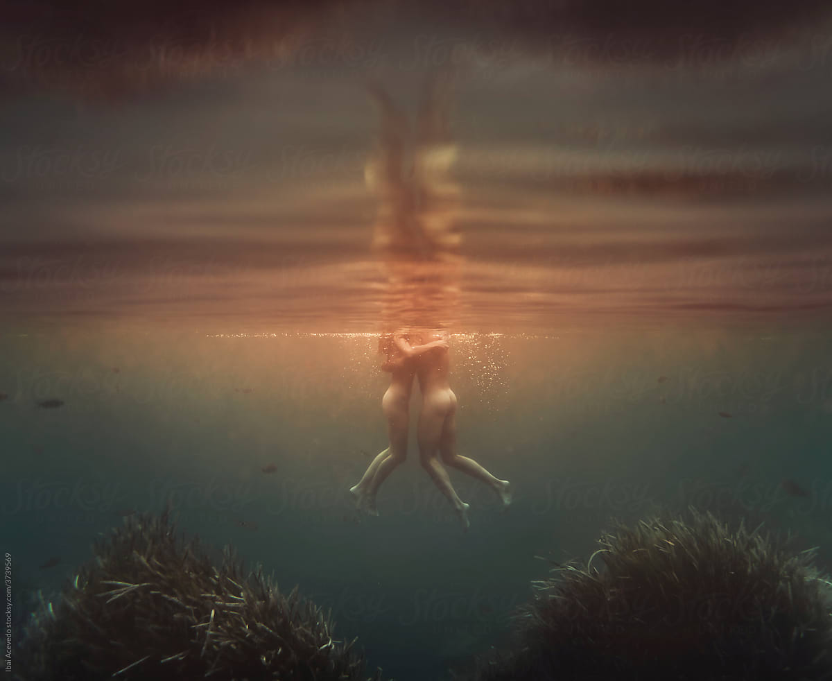 Underwater dreamlike couple\'s hug