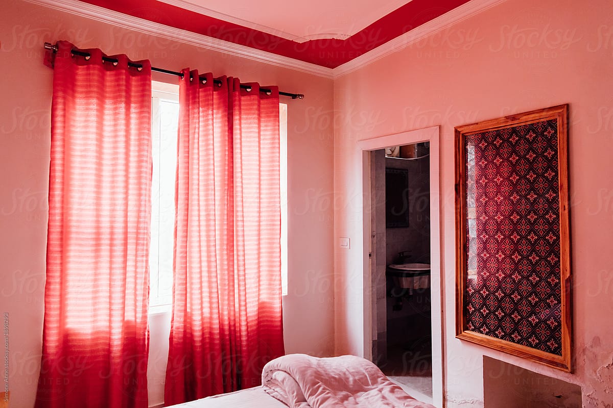 A pink room with red and pink curtains