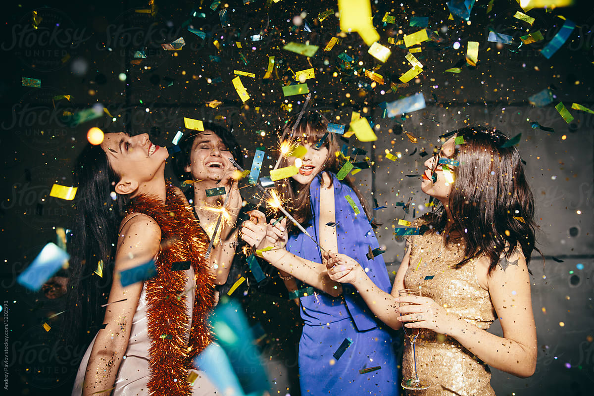 Four female posing in confetti
