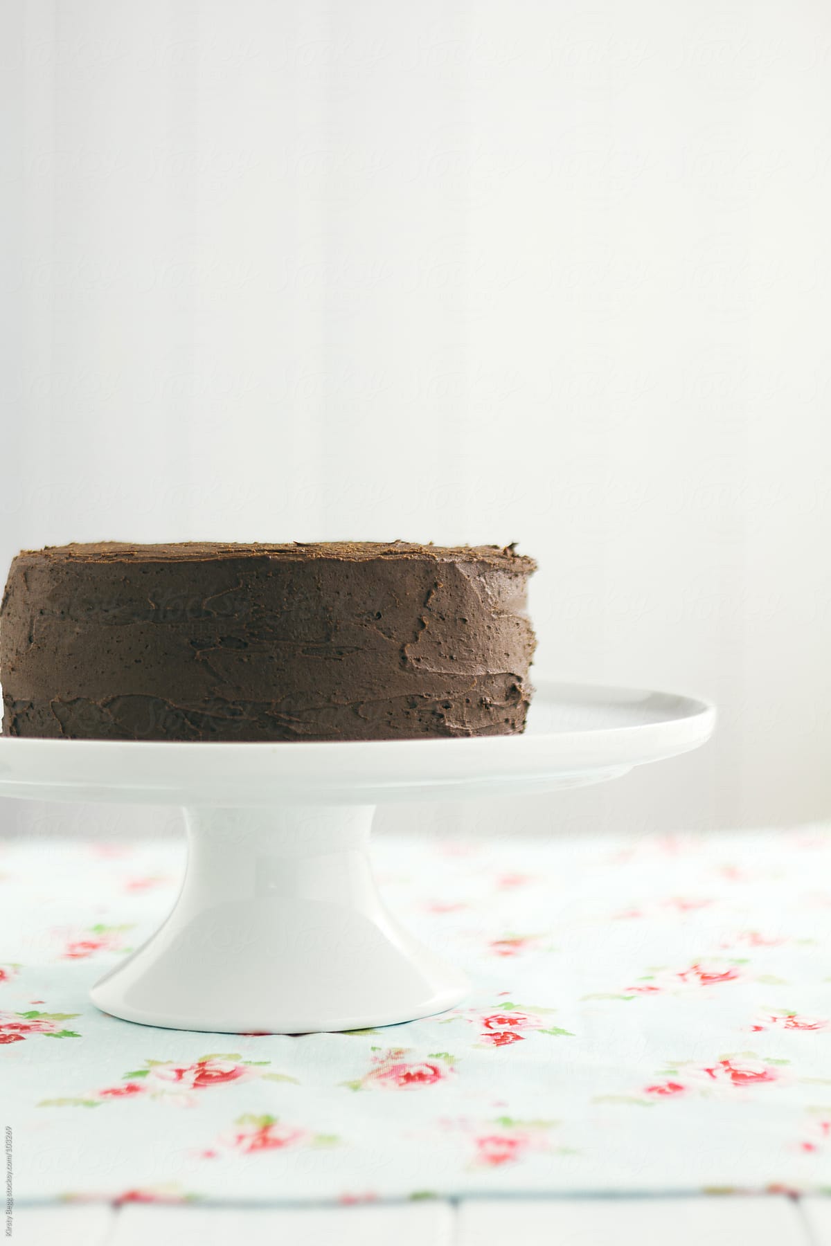 Chocolate buttercream  chocolate cake on white cake stand
