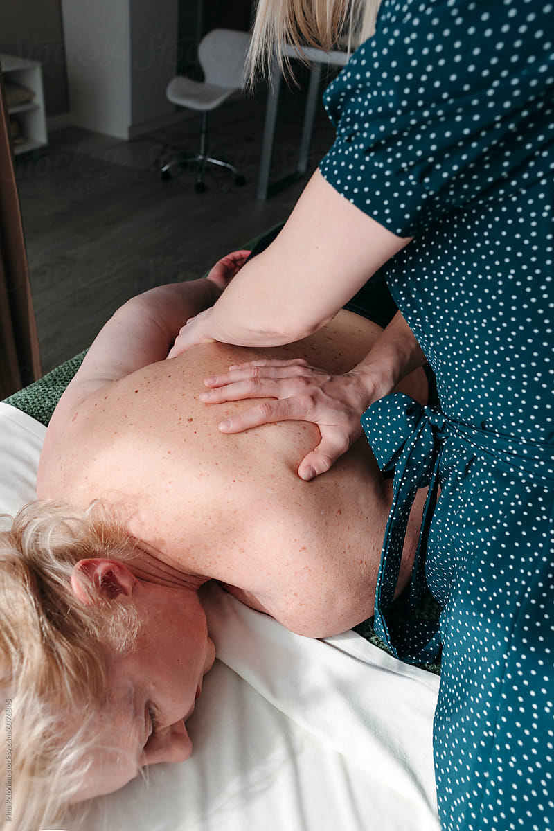 Therapist Giving Back Massage in Clinic