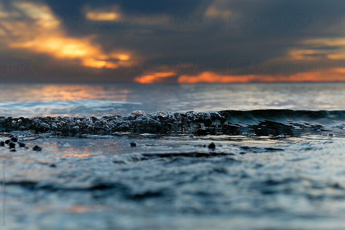 Surface Level shot of a Small Wave at Sunset