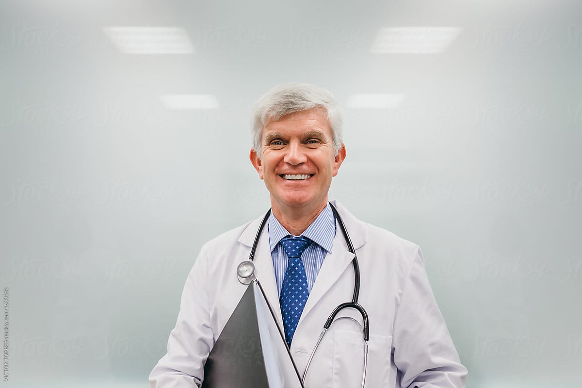 Cheerful adult doctor with papers
