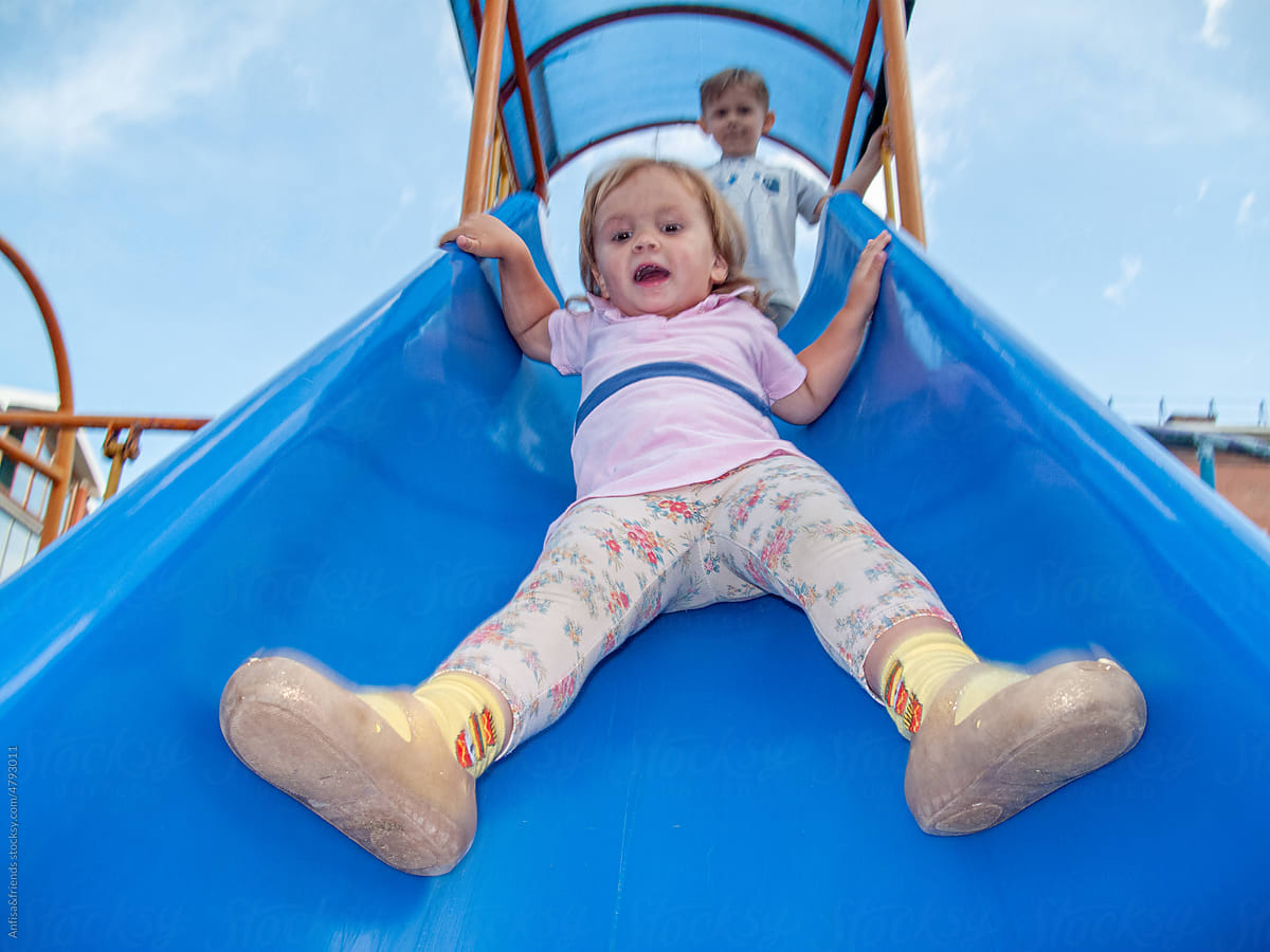 girl on playground slide