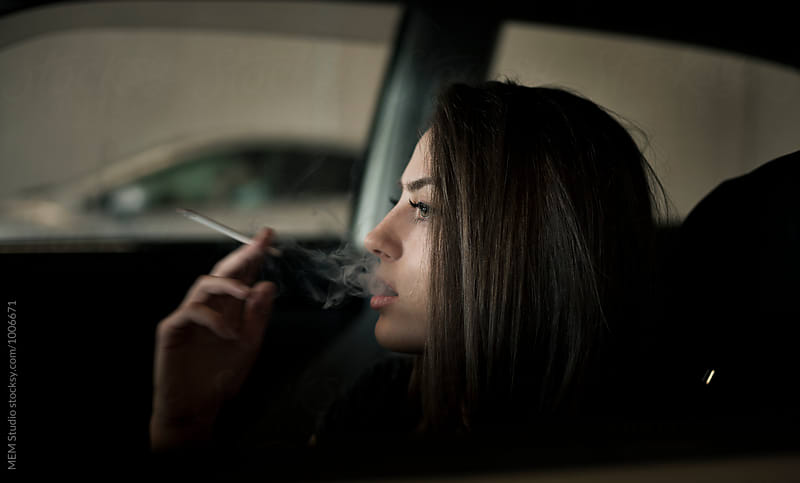 Beautiful woman driving and smoking