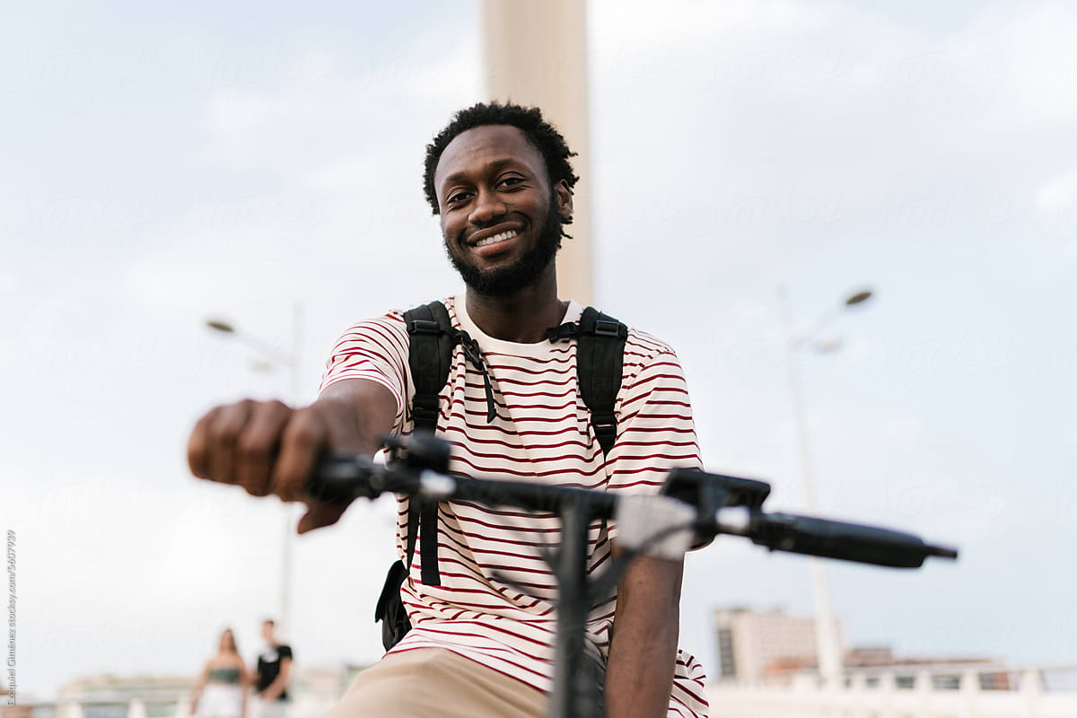 Smiling black man sitting on eco electric bike