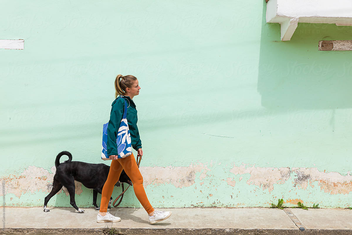 Woman walking down the street with her dog