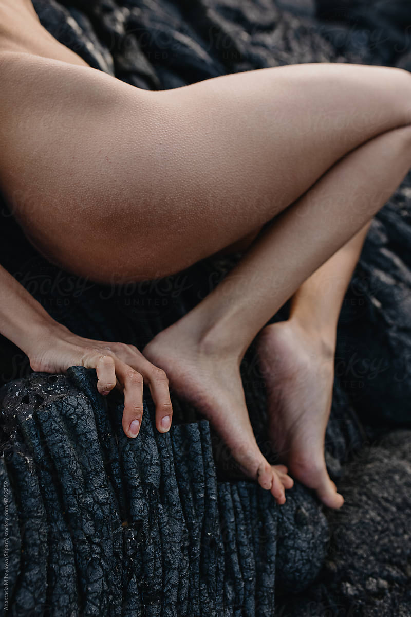 Close up photo of woman\'s feet on the lava