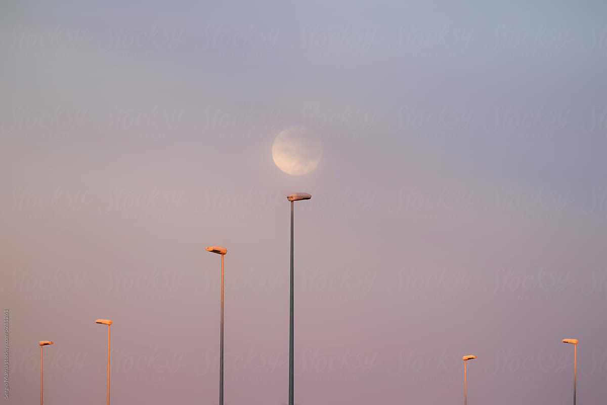 Full moon over streetlights
