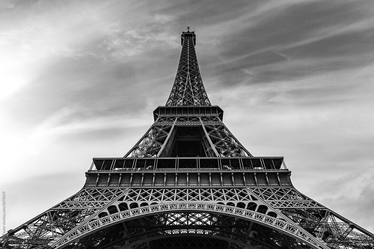 Black and White Image Of The Eiffel Tower Against Wispy Sky
