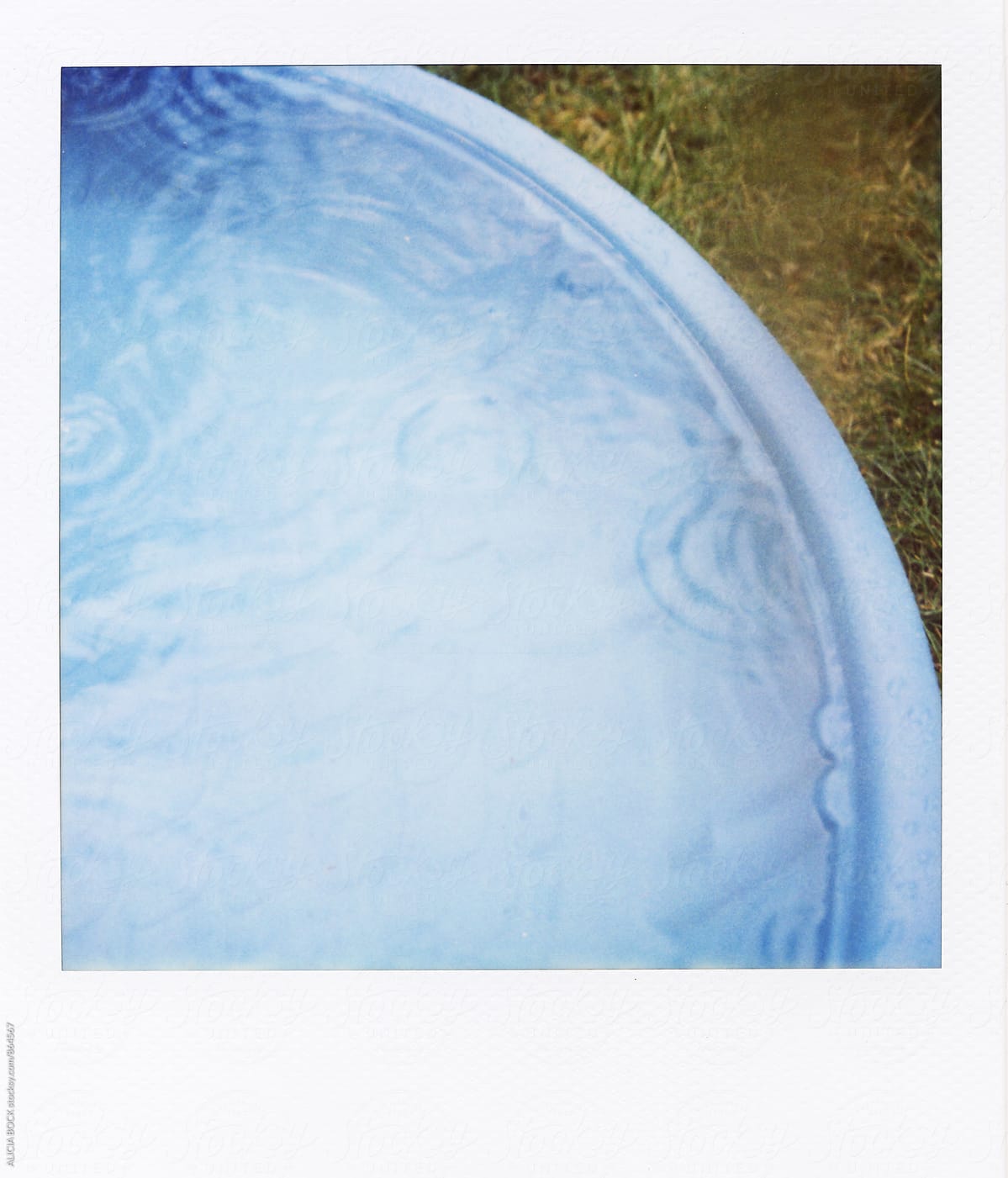Polaroid Photograph of Small Kiddie Pool In The Rain