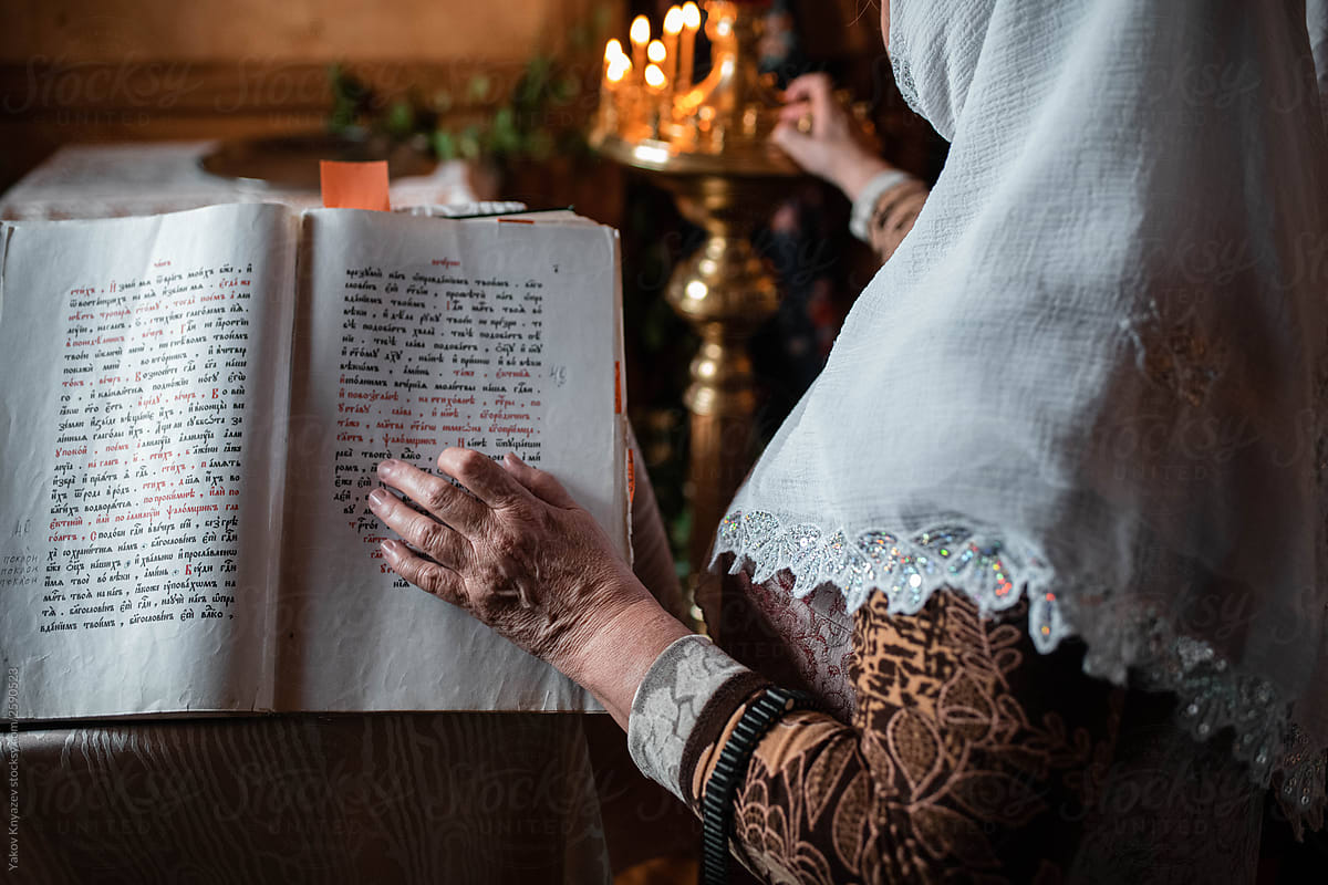 Old Lady\'s Hand Resting On An Open Bible