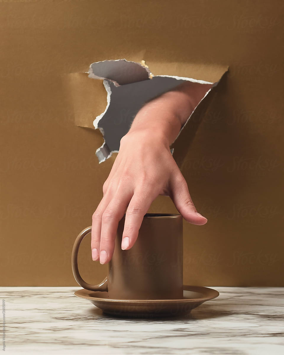 Hand Taking Coffee Cup Through Wall