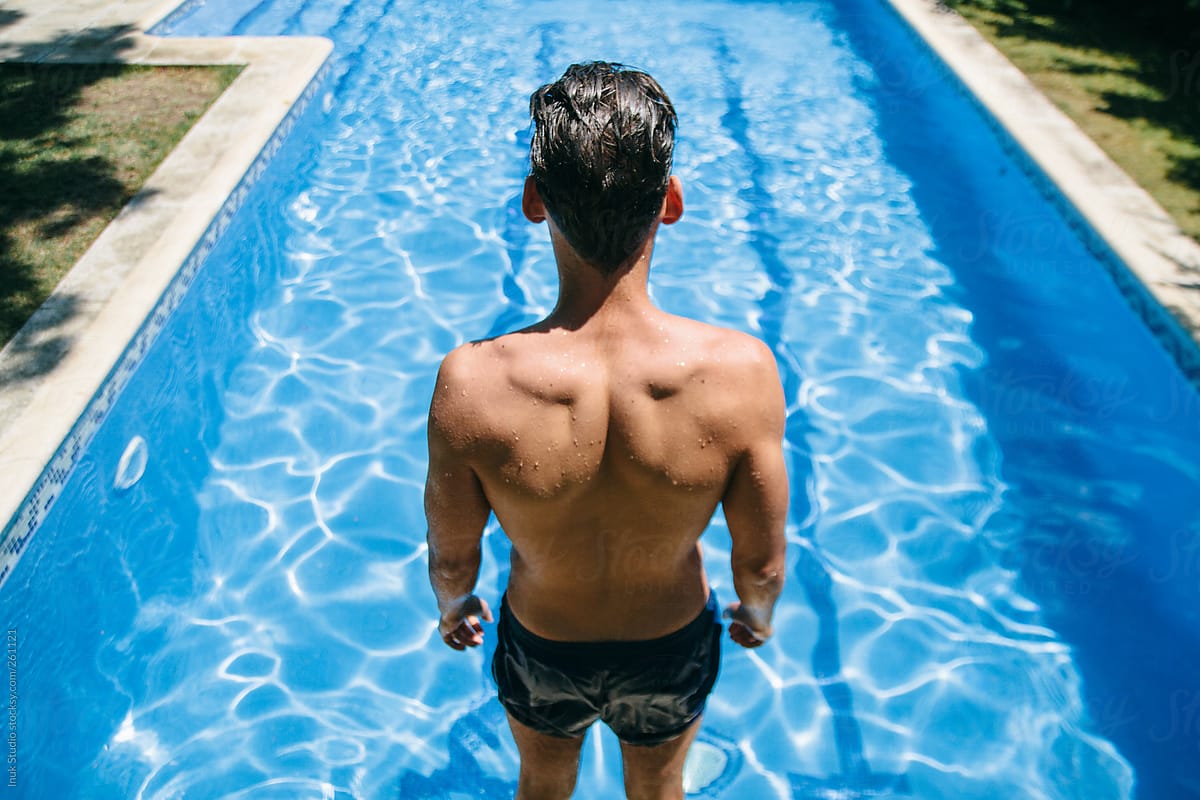 "Young Man In Front Of A Pool Before Jumping Into A Pool" by Stocksy