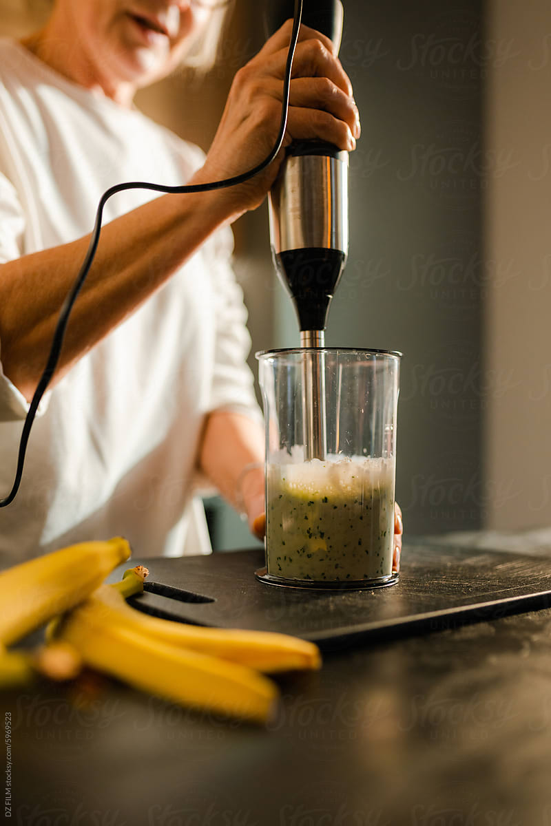 A woman makes smoothies at home