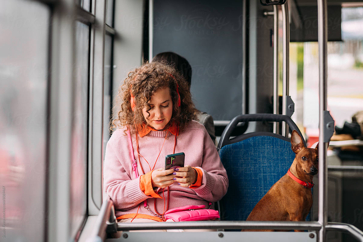 Girl and dog riding bus