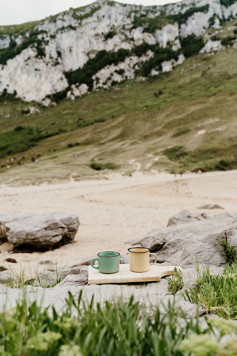 Coffe mugs on wild beach
