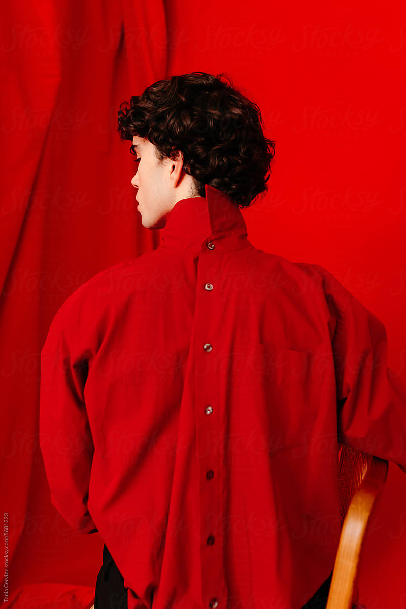 Young male model wearing red shirt backwards
