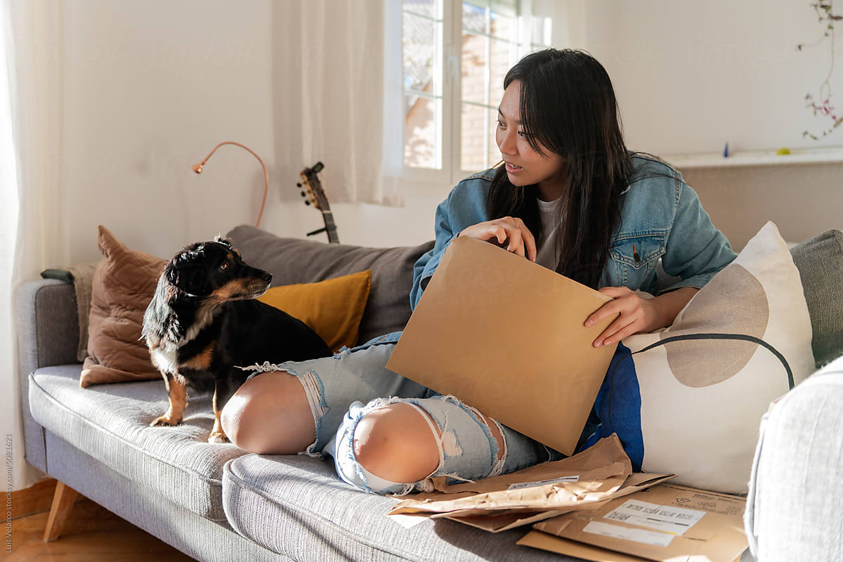 Girl With Dog, Opening E-commerce Postal Packages At Home.