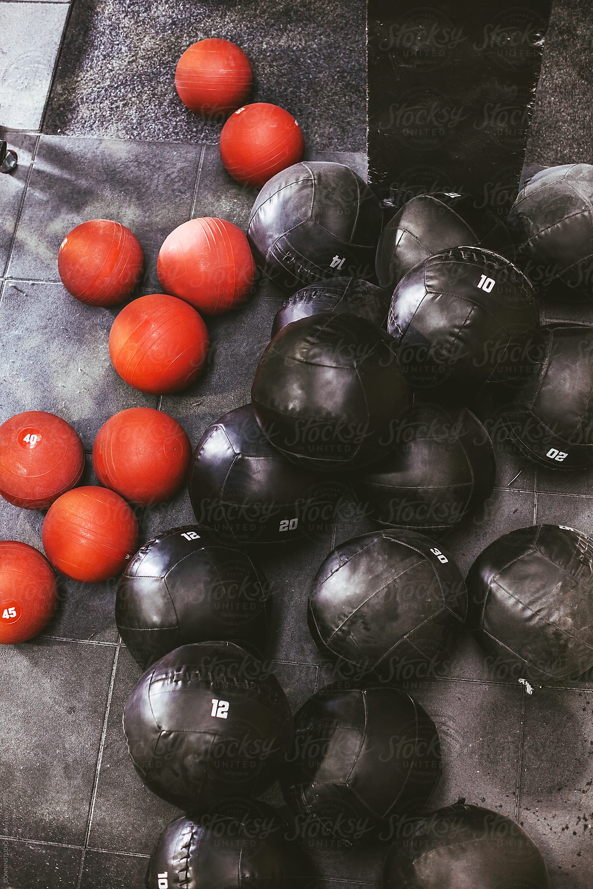 Red and black weighted balls in a gym.