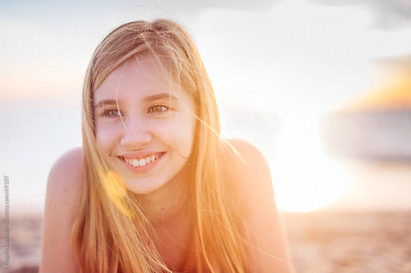 Smiling Teenage Girl At Sunset By Angela Lumsden Stocksy United 