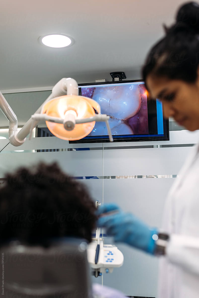 Dentist examining patient\'s teeth