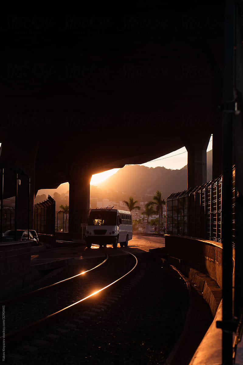 sunset light casting railway under the bridge