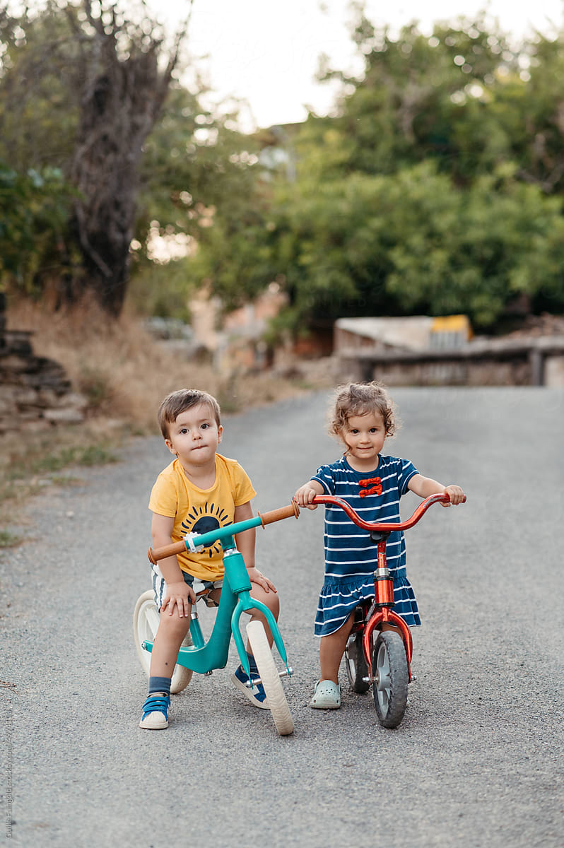Siblings on balance bikes
