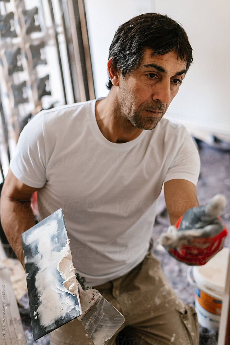 Man making repairs in a house.