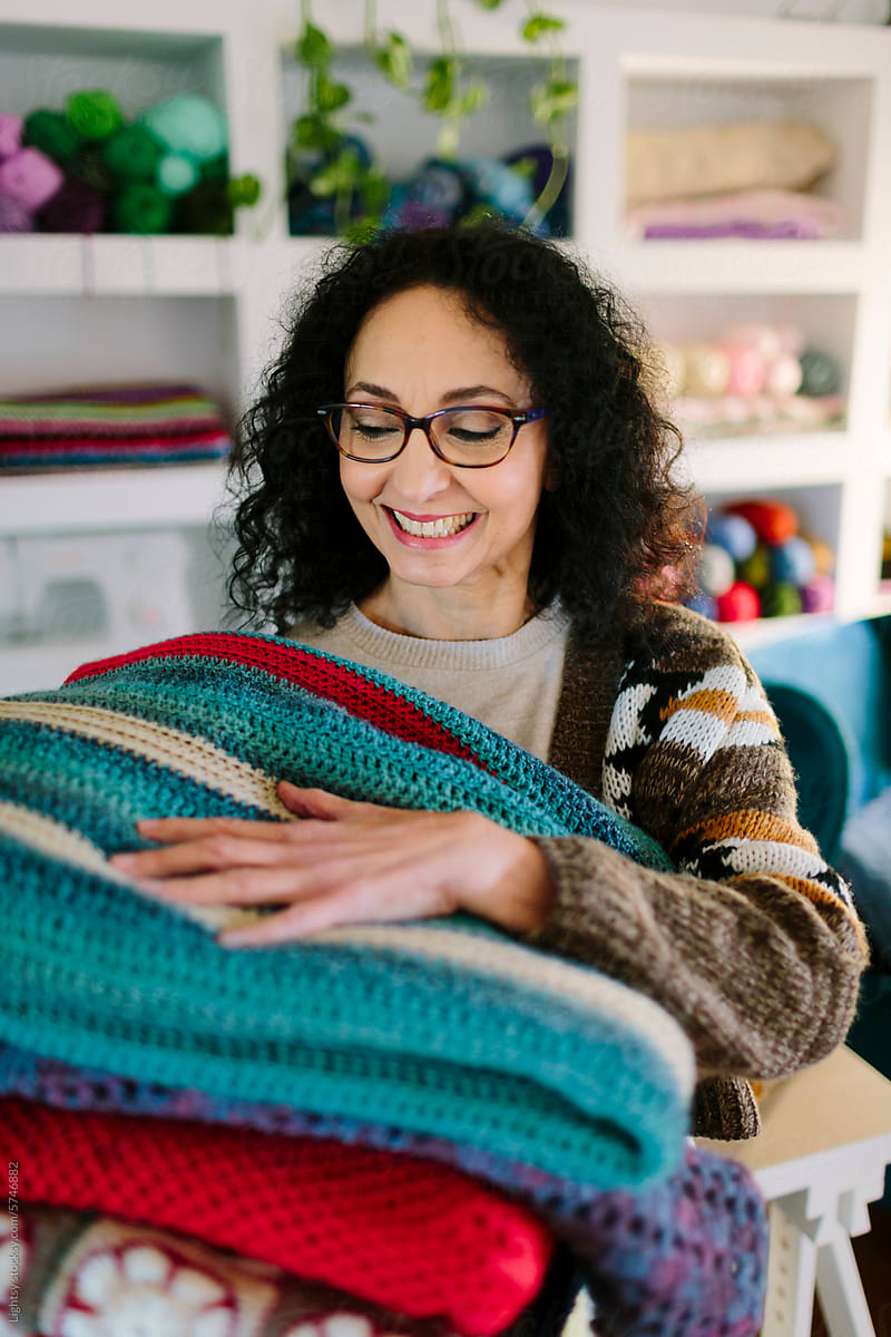 Woman with crochet blankets