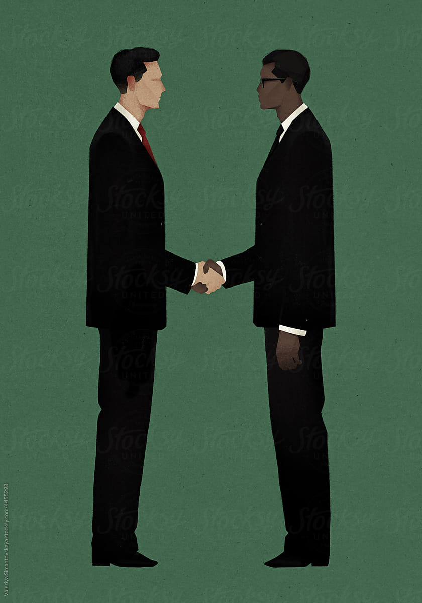 two young men in suits shaking hands