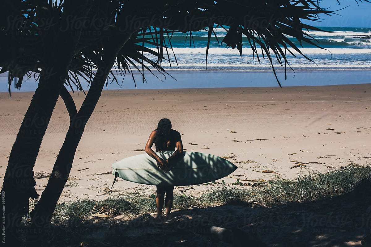 A Young Female Surfer Holding A Surfboard In The Shade By Stocksy Contributor Gary Parker