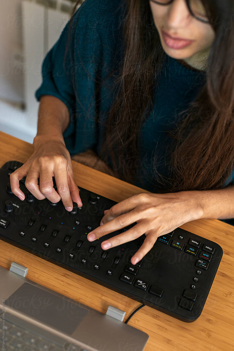 Arab woman editing video with editing console