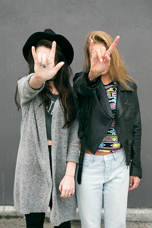 Unrecognizable Friends Covering Face With Rock And Roll Signs By Danil