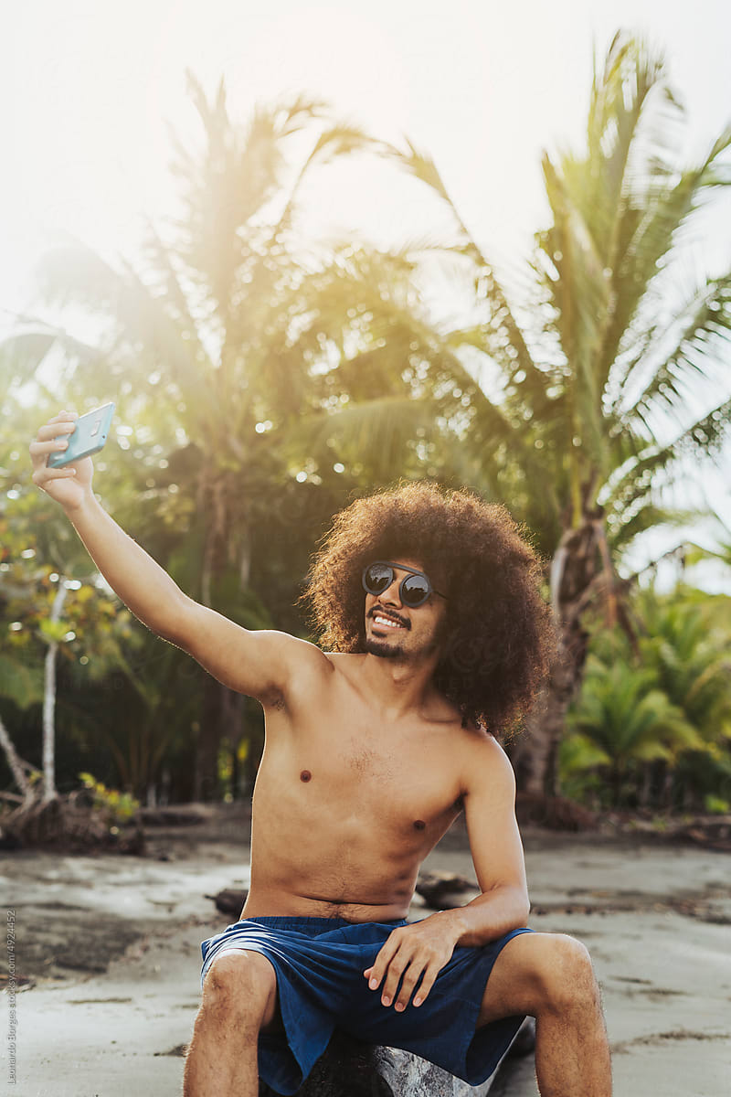 Man with afro hair on the beach.